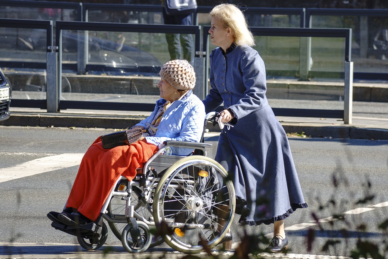 caregiver pushing a senior in a wheel chair