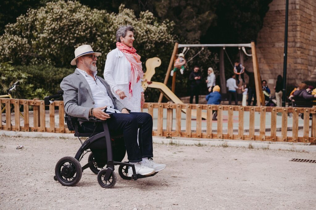 Senior couple enjoying a walk outdoors with a mobility aid for seniors in use